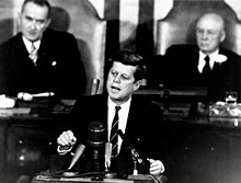 President John F. Kennedy addresses a joint session of Congress, with Vice President Lyndon B. Johnson and House Speaker Sam Rayburn seated behind him