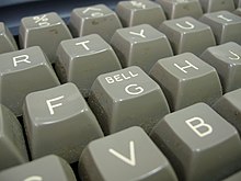 photograph of the keyboard for an Osborne 1 computer showing how the word "Bell" is also printed on the key for the letter "G"