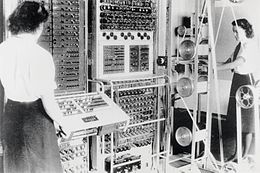 Two women are seen by the Colossus computer.